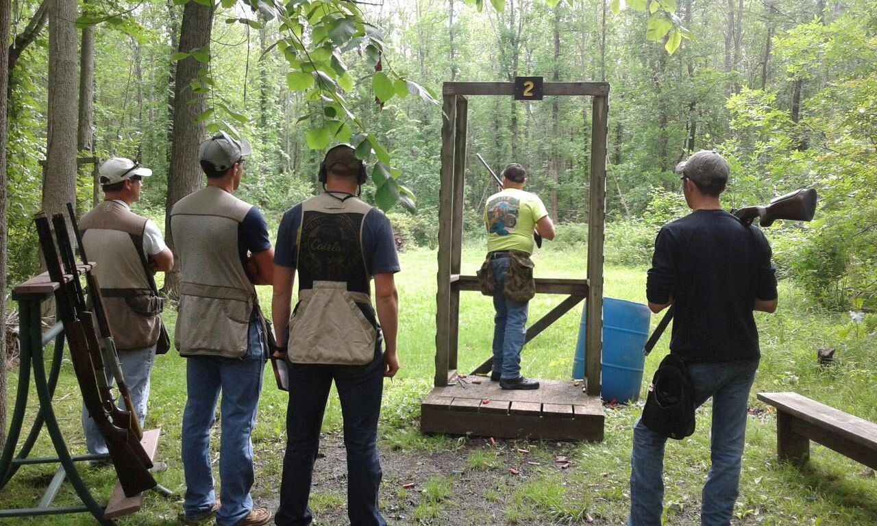 Shooters waiting at a sporting clays station in the woods