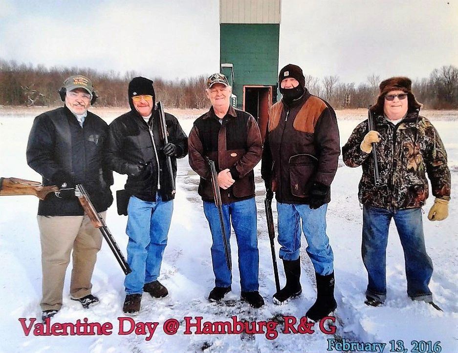 Five club members with shotguns standing in the snow at the trap fields, Valentine's Day 2016